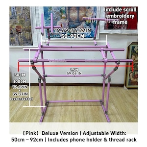 May include: A pink, adjustable embroidery frame with a phone holder and thread rack. The frame's width adjusts from 19.69 to 36.22 inches (50-92 cm). The frame is 59.06 inches (1.5 m) wide and extends from 19.69 to 39.37 inches (50-100 cm).
