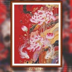May include: Framed cross-stitch art featuring a vibrant red background with white and pink lotus flowers, koi fish, and gold accents. The artwork includes the text "ZZ7079-" at the bottom. The piece is framed in a brown wooden frame.
