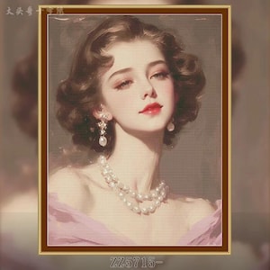 May include: A framed portrait of a woman with brown hair and red lipstick. She wears pearl earrings and a pearl necklace. The portrait is in a gold frame, with the text "ZZ5715-" at the bottom.