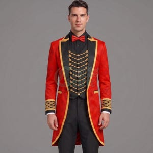 May include: A red tailcoat jacket featuring black lapels with gold trim, paired with a black waistcoat adorned with gold chain details and buttons. The ensemble includes a red bow tie, black trousers, and cuffs decorated with intricate gold embroidery.