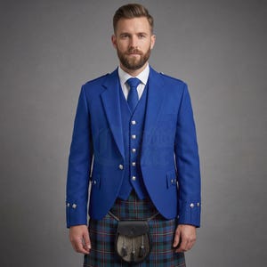 May include: A royal blue jacket and matching waistcoat with silver buttons, worn with a blue and green tartan kilt. The outfit features a blue necktie, a white collared shirt, and a black leather sporran detailed with silver hardware and black tassels.