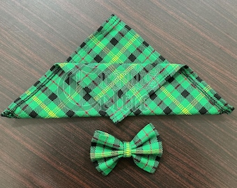 May include: A green and black plaid bow tie and pocket square set. The bow tie and pocket square are made of a soft, woven fabric.