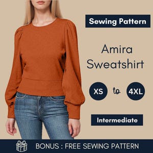 May include: An orange Amira sweatshirt sewing pattern. The sweatshirt has long, puffed sleeves and a fitted waist. The pattern is available in sizes XS to 4XL and is rated as intermediate. The image also includes the text "Sewing Pattern".