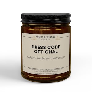 May include: A brown glass candle jar with a black lid and a beige label. The label reads WICKS & WHIMSY CANDLE CO., DRESS CODE OPTIONAL, Workwear traded for comfort-wear, HANDPOURED, 100% NATURAL, AROMATHERAPY, NET 255g, BURN TIME: UP TO 50 HOURS.