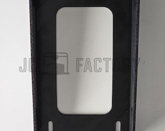 May include: A black rectangular frame with a central cutout and four small holes. The frame has a textured surface on the sides and the text "JO FACTORY" is visible in the lower center.