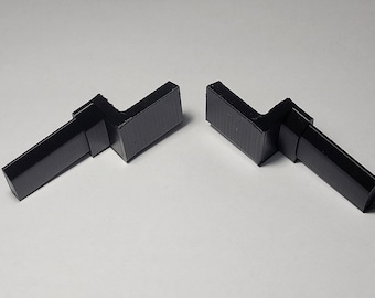 May include: Two black plastic corner brackets, each with a 90-degree angle and a flat surface.