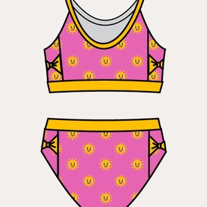 May include: Pink two-piece swimsuit set with a repeating pattern of smiling suns. The top has narrow straps and a yellow trim. The bottoms also have yellow trim. The word "Back" and "Narrow Straps" are printed on the image.