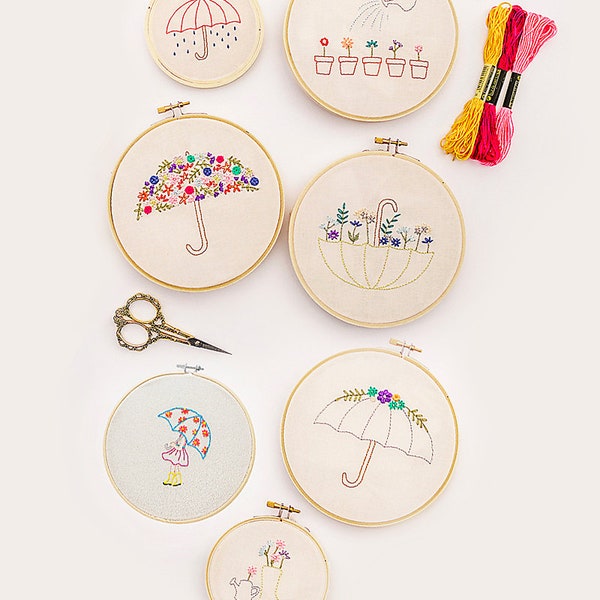 Breezewood PDF Hand Embroidery Pattern, including umbrella designs, potted flowers, watering can, child with an umbrella, and a rain boot