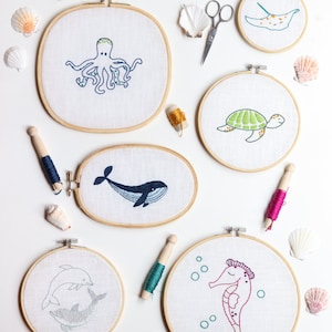 Atlantis Hand Embroidery PDF Pattern, showcasing multiple sea animals: seahorse, sea turtle, octopus, stingray, dolphin duo and whale