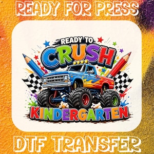 May include: A colourful graphic design featuring a blue monster truck with flames, flanked by two pencils and checkered flags. The text reads READY TO CRUSH KINDERGARTEN in bold, multi-coloured letters. The design is set against a white background.