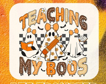 May include: DTF transfer design with the text "READY FOR PRESS" at the top and "DTF TRANSFER" at the bottom. The design features the words "TEACHING MY BOOS" in orange and brown, with ghost characters holding books and a pencil.