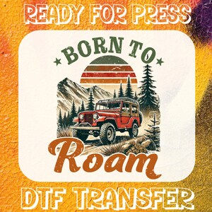 May include: A red jeep with a white roof and a wooden back is driving through a forest. The jeep is surrounded by trees and mountains. The text "Born to Roam" is written in a vintage style font. The text "Ready for Press" and "DTF Transfer" are also written on the image.