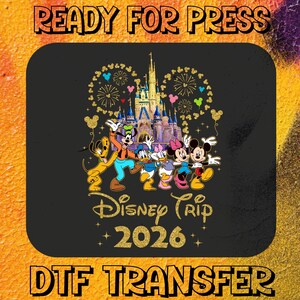May include: Black DTF transfer featuring Disney characters, including Mickey and Minnie Mouse, in front of a castle. The words "Disney Trip 2026" are in gold script. The words "Ready for Press" and "DTF Transfer" are at the top and bottom.
