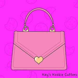 May include: Pink purse cookie cutter with a gold heart-shaped clasp. The purse has a handle and gold accents. The background is a bright pink with cookie illustrations. The text "Kay's Kookie Cutters" is at the bottom.