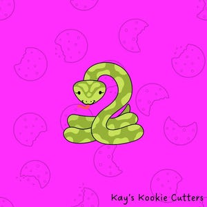 May include: A green cartoon snake cookie cutter with a pink tongue, on a bright pink background with cookie outlines. The text "Kay's Kookie Cutters" is in the bottom right corner.