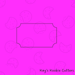 May include: A black cookie cutter in the shape of a rectangular label with rounded corners. The background is a bright pink with a pattern of cookie outlines, some with bites taken out. The text "Kay's Kookie Cutters" is in the bottom right corner.
