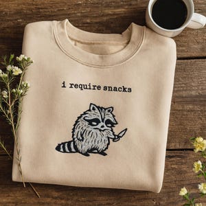 I Require Snacks Embroidered Raccoon Sweatshirt, Funny Goblincore Animal Hoodie, Cozy Snack Lover Gift, Embroidered T Shirt