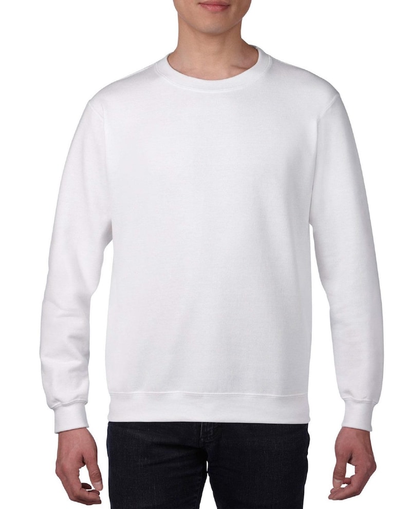 May include: A plain white crew neck sweatshirt. The long-sleeved top is made of a soft material and has a ribbed hem and cuffs. The sweatshirt is a versatile piece of apparel.