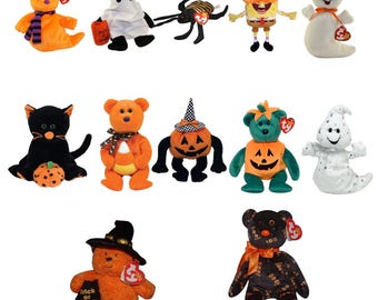 May include: A collection of Halloween-themed plush toys, including bears, cats, ghosts, and a spider. The toys feature various costumes and designs, such as pumpkins, witch hats, and candy corn. Each toy has a tag.