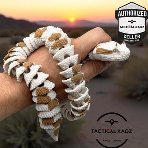 May include: A white and tan articulated snake figurine with a textured, segmented body and two small horns on its head. The figure features a flexible design and includes a badge in the corner that reads Authorised Tactical Kaoz Seller.