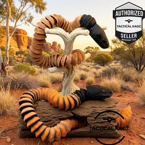 May include: Two articulated snake figures featuring segmented bodies with black heads and orange-brown scales. One snake is coiled around a light-coloured branch, while the other rests on a dark log. Text includes AUTHORIZED TACTICAL KAOZ SELLER.