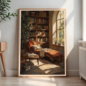 May include: A framed wall art print depicting a cozy reading nook with a wooden bookshelf filled with books, a chaise lounge chair with a light-colored cushion, a small round side table with a book and cup, and a stack of books on the floor.