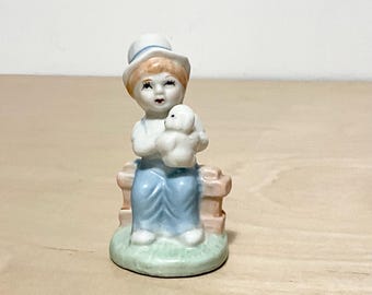 Vintage Boy Figurine in Overalls Sitting on a Fence Holding a  Lamb