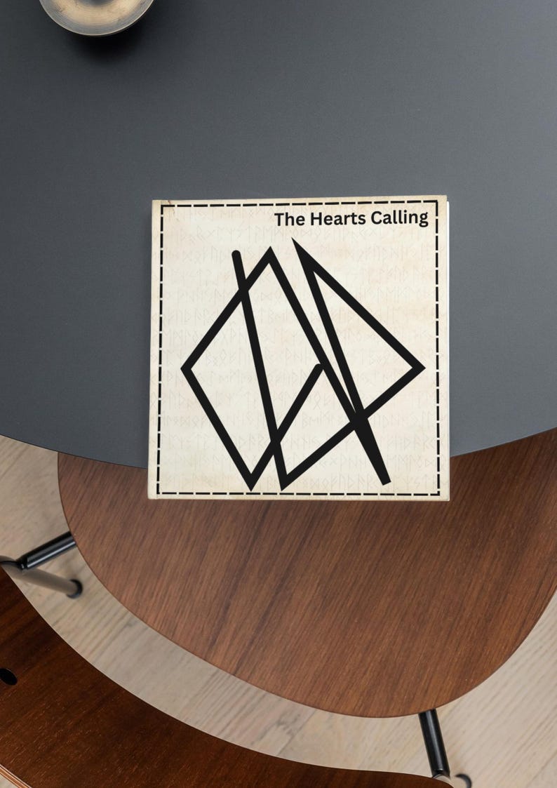 May include: A wooden sign with a black geometric design and the text "The Hearts Calling" printed on it.