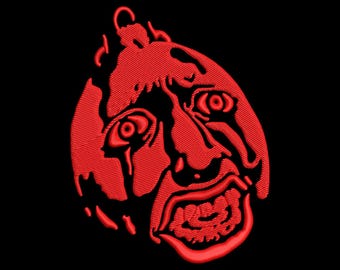 May include: Red embroidered design of a face with a teardrop, open mouth, and intense eyes on a black background. The design has a textured, stitched appearance, with a detailed expression.