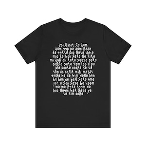 May include: Black t-shirt with white text in a circular pattern. The text appears to be a poem or a series of phrases. The shirt is a basic crew neck style, suitable for casual wear.