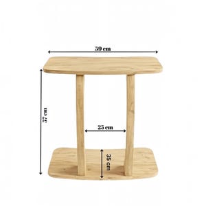 May include: A light wood side table with a rectangular top and base connected by two vertical supports. The table features dimensions of 59 cm in width, 57 cm in height, 25 cm between the supports, and a base depth of 35 cm as indicated by text.