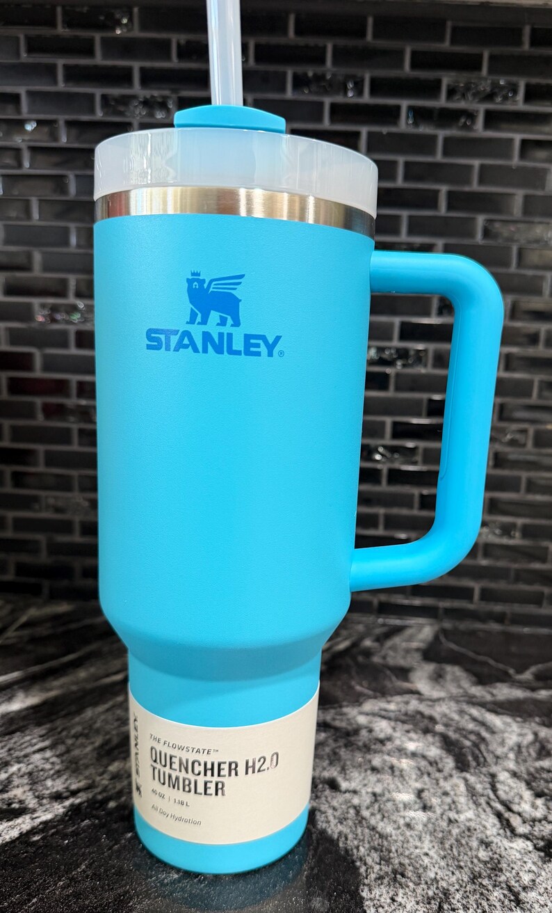 May include: A set of three ceramic mugs with a speckled, matte finish in cream, light grey, and dark grey. Each mug has a simple, minimalist design, suitable for coffee or tea.