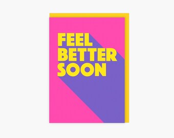May include: A greeting card with the words "FEEL BETTER SOON" in yellow, bold letters. The text is set against a vibrant background of pink and purple, with a yellow border.