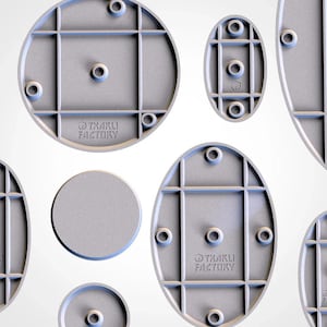 May include: A selection of light grey, 3D-printed plastic components in various shapes, including circles and ovals. Each piece has a grid-like structure and several holes. The text "TXARLI FACTORY" is printed on some of the components.