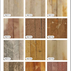 May include: A grid of mosaic tile samples in various colors and textures. The tiles are arranged in vertical strips, showcasing a range of natural stone finishes. The image includes the "HAAS MOSAIC" logo and sample codes.