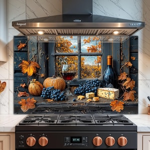 May include: A kitchen backsplash featuring a rustic window scene with a glass of red wine, a bottle of wine, pumpkins, grapes, and cheese. Autumn leaves and a view of a vineyard are visible through the window.