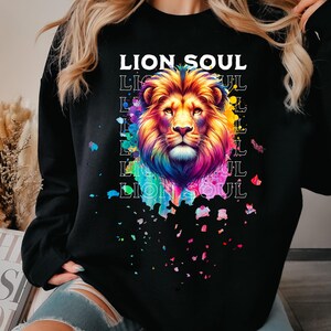 May include: Black sweatshirt with a colorful lion graphic and the text "Lion Soul" repeated in a layered pattern.