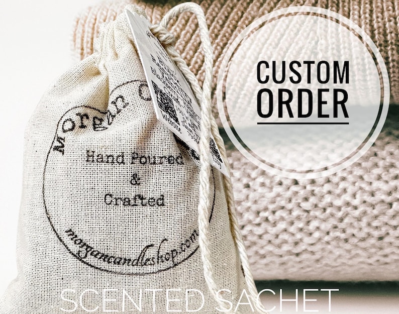 May include: A white cotton drawstring bag with black text that reads "Morgan Candleshop.com" and "Hand Poured & Crafted". The bag is sitting on a beige knitted fabric with the text "CUSTOM ORDER" in a circle.
