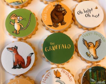 May include: A collection of decorated cookies with various illustrations and text. Designs include a mouse, a fox, an owl, and the text "The Gruffalo", "Oh help! Oh no!", and "Happy Birthday". The cookies have a scalloped edge.