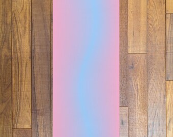 May include: A pink and blue yoga mat with the name "Sophie" printed on the bottom.