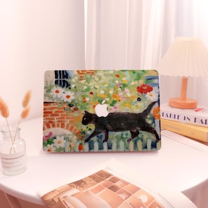May include: A laptop skin with a colorful painting of a black cat walking through a garden with flowers. The painting is in a painterly style with visible brushstrokes. The laptop skin has the Apple logo in the center.