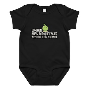 May include: Black baby bodysuit with the text "LORRAIN AUSSI DUR QUE L'ACIER AUSSI DOUX QUE LA BERGAMOTE" and a smiling green pear graphic. The bodysuit is short-sleeved and has a round neckline.