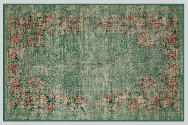 May include: A rectangular, distressed-look rug with a teal green background and a floral border. The border features pink and cream-colored flowers and foliage. The rug has a faded, vintage appearance, with a darker green border.