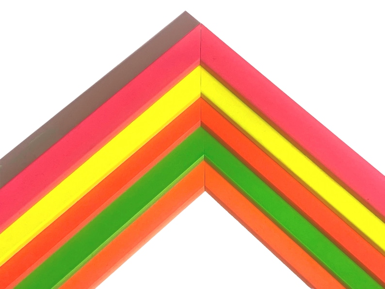 May include: A corner section of a multi-layered picture frame featuring five distinct angled strips. The colors arranged from the outermost to the innermost layer are brown, neon pink, bright yellow, orange, and a vibrant lime green.