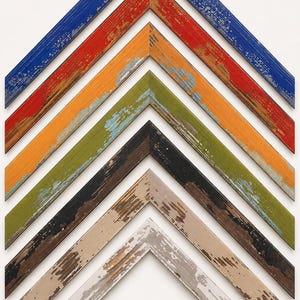May include: A collection of six V-shaped picture frame corner samples arranged vertically. Each frame features a distressed, weathered finish with visible wood grain and paint chipping, showcasing colors in blue, red, orange, green, black, and beige.