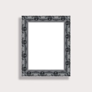 May include: A rectangular, ornate picture frame with a silver-grey finish. The frame features detailed floral and scrollwork patterns along its edges, creating a vintage aesthetic. The interior is a bright white, ready for a photo or artwork.
