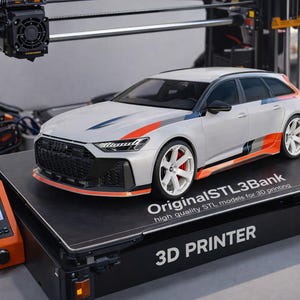 May include: A silver model car with orange and blue accents sits on a 3D printer. The printer is black and orange, with a screen displaying a graphic. The car has white wheels with red brake calipers. Text on the printer reads "3D PRINTER" and "OriginalSTL3Bank".