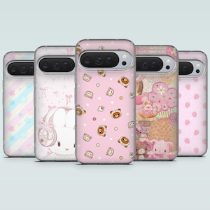 May include: A collection of five phone cases with various designs. The cases feature pastel colors, including pink, blue, and white. Designs include a bunny, bears, strawberries, and a cupcake. The cases are made of a clear material.