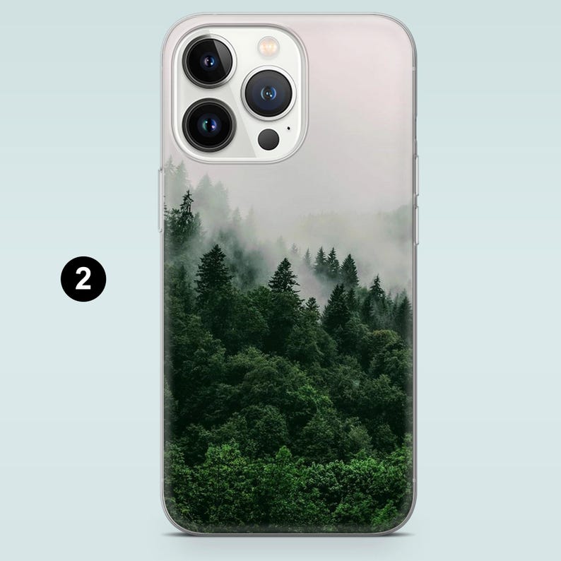 May include: A clear phone case with a foggy forest scene printed on the back. The forest is a dark green with a light mist.