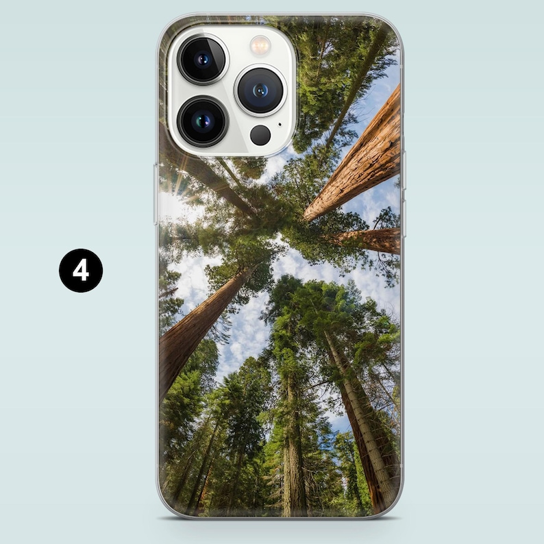 May include: A phone case with a photo of tall trees reaching up to a bright blue sky. The trees are brown and green, and the sky is clear and cloudless.